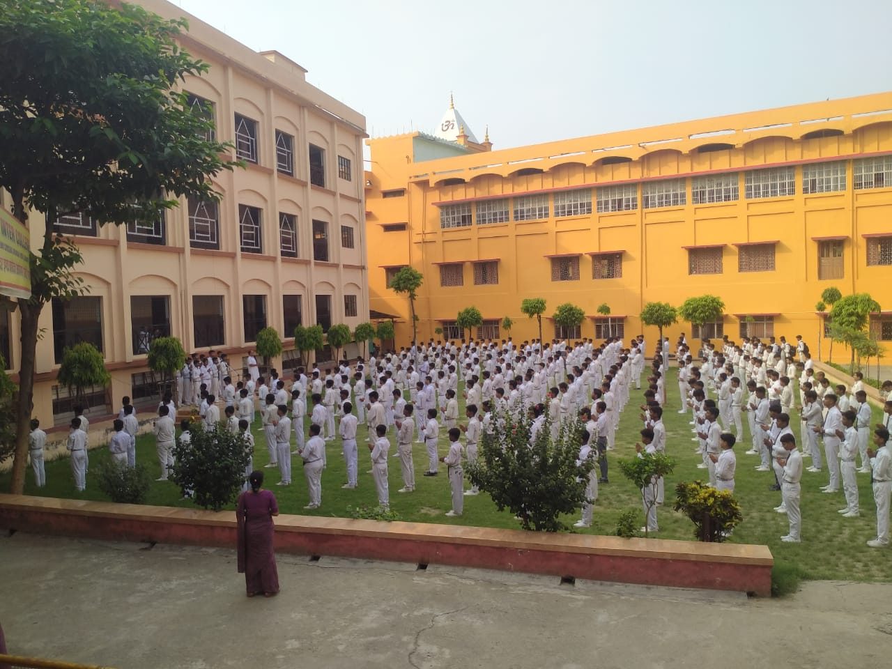 Large gathering of students and teachers on the school ground